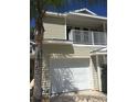 Tan two-story townhouse with attached garage and balcony at 1817 Hammocks Ave # 1817, Lutz, FL 33549