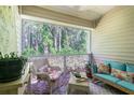 Relaxing screened porch with wicker furniture at 1817 Hammocks Ave # 1817, Lutz, FL 33549