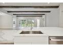 Modern kitchen island with quartz countertop and stainless steel sink at 6257 Hidden Branch Dr, Apollo Beach, FL 33572