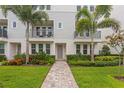 Townhome entry with a paved walkway and landscaping at 2442 W Mississippi Ave # 6, Tampa, FL 33629