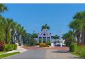 Picturesque community entrance to Little Harbor, framed by palm trees and lush landscaping with brick paved drive at 549 Bahia Beach Blvd, Ruskin, FL 33570