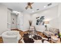 Elegant living room featuring hardwood floors, a ceiling fan, and neutral decor creating a cozy atmosphere at 6030 Printery St # 105, Tampa, FL 33616