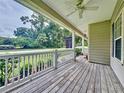 Front porch with white railings and view of a tree-lined street at 12731 Timber Run, Dade City, FL 33525