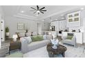 Spacious living room featuring modern decor, sleek floors, and an open floor plan to the kitchen and dining area at 2724 W Dewey St, Tampa, FL 33607