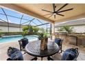 Outdoor kitchen and pool with covered patio and seating area at 30723 Lindentree Dr, Wesley Chapel, FL 33543