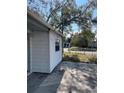 Side view of a house showing white siding at 1716 Lancelot Loop, Tampa, FL 33619