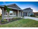 Two-story home with gray siding and landscaping, two car garage at 16115 69Th Lane E Pl, Parrish, FL 34219
