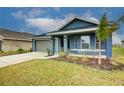 Two-car garage and well-manicured lawn enhance this lovely home's exterior at 7018 162Nd E Pl, Parrish, FL 34219