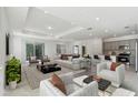 Open living room showcasing a spacious layout, neutral color palette, and ample natural light at 1279 Kazaz Ct, Zephyrhills, FL 33540