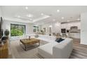 Open living room featuring a large sectional sofa and plenty of natural light at 1285 Kazaz Ct, Zephyrhills, FL 33540