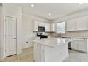 Modern kitchen featuring white cabinets and a large island at 1244 Kazaz Ct, Zephyrhills, FL 33540