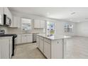 Open concept kitchen with island and stainless steel appliances at 1244 Kazaz Ct, Zephyrhills, FL 33540