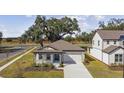 House with driveway and landscaping, viewed from above at 37886 Clinch Cir, Zephyrhills, FL 33540