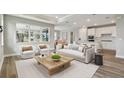 Bright living room with open floor plan, featuring comfortable seating and large windows at 37886 Clinch Cir, Zephyrhills, FL 33540