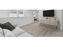 Bright loft area with plush carpet and a built-in media console at 1209 Kistna Dr, Zephyrhills, FL 33540