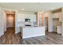 Open kitchen with island, stainless steel appliances and white cabinets at 10304 Surrey Rose Dr, San Antonio, FL 33576