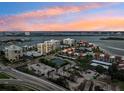 Aerial view of waterfront community with tennis courts and pool at 851 Bayway Blvd # 104, Clearwater Beach, FL 33767