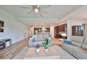 Open living room featuring hardwood floors, recessed lighting, and a ceiling fan at 6308 Waves End Pl, Apollo Beach, FL 33572