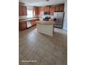 Spacious kitchen featuring stainless steel appliances, an island, and ample cabinet space at 4756 Somerset Hill Ln, Riverview, FL 33578