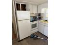 White kitchen appliances and cabinets with tile floor at 27466 Us Highway 19 N # 9, Clearwater, FL 33761