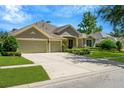 A large house with a three-car garage and manicured lawn at 806 Red Ash Ct, Seffner, FL 33584