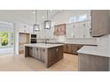 Modern kitchen with two-toned cabinetry, quartz countertops, and large island at 4608 Majestic Hills Loop, Brooksville, FL 34601