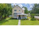 Beautiful two-story home featuring a bay window and covered front porch with rocking chairs at 14006 5Th St, Dade City, FL 33525