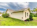 Side view of the house showcasing stucco exterior and landscaping at 1501 63Rd W St, Bradenton, FL 34209