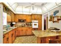 Galley kitchen with wood cabinets and granite countertop at 731 E Lumsden Rd, Brandon, FL 33511