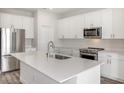 Modern kitchen with white cabinets, stainless steel appliances, and a large island at 10317 Fieldstone Myrtle Way, San Antonio, FL 33576