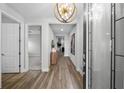 Bright and spacious entryway with wood floors and a stylish light fixture at 9120 Warm Springs Cir, Parrish, FL 34219