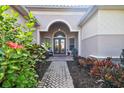 Charming front entrance with double doors and colorful landscaping at 5621 Rock Dove Dr, Sarasota, FL 34241