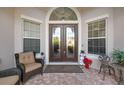 Inviting front porch featuring a seating area and seasonal decor at 5621 Rock Dove Dr, Sarasota, FL 34241