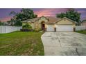 Two-car garage and well-maintained lawn at 1704 Cresswell Manor Ct, Dover, FL 33527