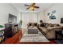 Spacious living room with hardwood floors, comfortable seating, and a large TV at 700 S Harbour Island Blvd # 722, Tampa, FL 33602