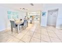 Bright dining area with light wood table, gray chairs, and kitchen view at 3035 Countryside Blvd # 14B, Clearwater, FL 33761