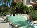 Small pond with a fountain and tropical landscaping at 3035 Countryside Blvd # 14B, Clearwater, FL 33761