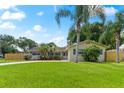 Attractive light-yellow brick ranch home with mature landscaping at 8402 Bedford Ln, Tampa, FL 33615