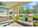 Relaxing screened patio with hot tub and seating area, overlooking a lush backyard at 121 Lacewing Pl, Valrico, FL 33594