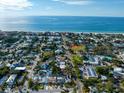 Aerial view of coastal neighborhood with oceanfront properties and lush greenery at 1401 Bay Palm Blvd, Indian Rocks Beach, FL 33785