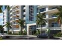 Building entrance with parking and tropical landscaping at 411 E Shore Drive # 705, Clearwater Beach, FL 33767