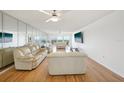 Bright living room with hardwood floors, mirrored wall, and stunning views at 1120 N Shore Ne Dr # 903, St Petersburg, FL 33701