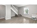 Modern interior with gray tile floors and staircase at 2601 Brigadoon Dr, Clearwater, FL 33759