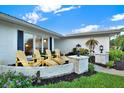 Relaxing patio area with yellow adirondack chairs at 14542 Anchorage Cir, Seminole, FL 33776