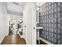 Stylish powder room with unique wallpaper, pedestal sink, and modern fixtures at 2527 W Maryland Ave # A, Tampa, FL 33629