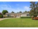 House exterior showcasing a well-maintained lawn and landscaping at 613 79Th S Cir, St Petersburg, FL 33707