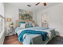 Bright bedroom featuring a decorative bed with stylish turquoise accents and a bathroom ensuite at 9282 Lake Chase Island Way # 9282, Tampa, FL 33626