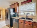 Modern kitchen with dark wood cabinets and black appliances at 504 Florida S Cir, Apollo Beach, FL 33572