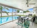 Inviting pool area with patio furniture, offering a relaxing outdoor space at 504 Florida S Cir, Apollo Beach, FL 33572