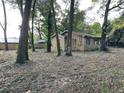 Partially cleared backyard with mature trees at 307 Tweed Ave, Seffner, FL 33584